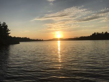 Scenic view of lake against sky during sunset