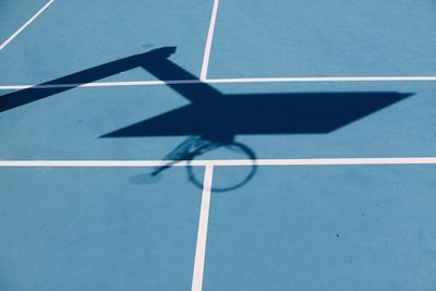 High angle view of basketball hoop shadow on blue court