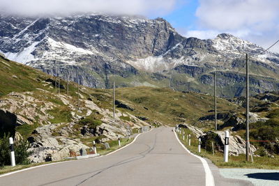 Road amidst mountains against sky