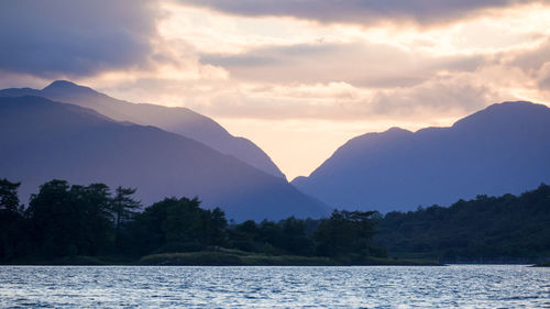 Scenic view of lake and mountains against sky