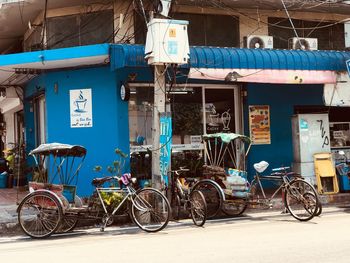 Bicycles parked on street against buildings