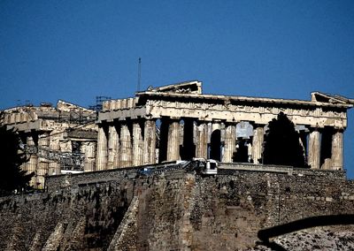 Low angle view of old ruins against clear blue sky