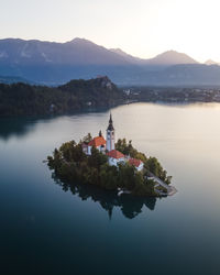 Aerial view of cerkev marijinega, a catholic church on a small island in the middle of bled lake 