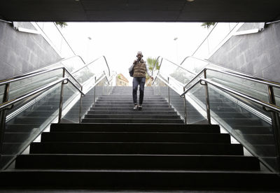 Full length of man on steps at subway station
