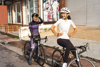 Smiling female cyclist on road