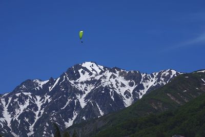 Low angle view of mountain against blue sky