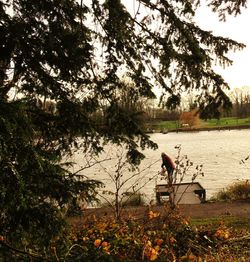 People relaxing on lakeshore