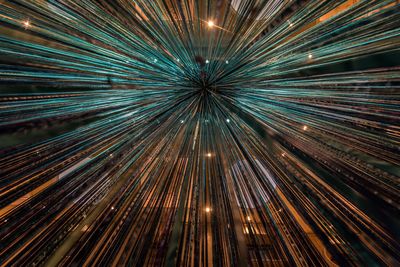 Abstract image of illuminated lights against sky at night