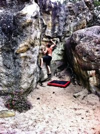 Full length of woman standing on rock