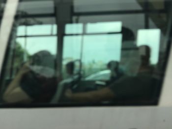 Defocused image of people seen through glass window