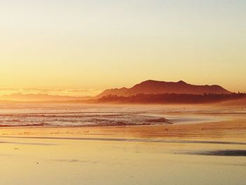 View of calm beach at sunset