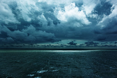 Scenic view of sea against storm clouds