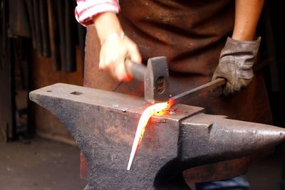 Close-up of man working on metal