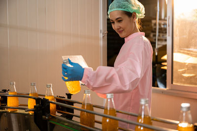 Portrait of young woman standing in laboratory