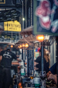 Person holding glass of illuminated city at night