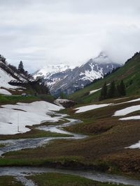 Scenic view of snowcapped mountains against sky