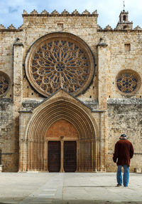 Rear view of man standing in historic building