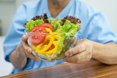 Midsection of woman holding food
