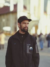 Portrait of young man standing in city