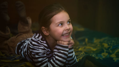 Cute girl smiling while relaxing at home