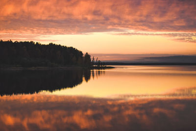 Scenic view of lake against orange sky