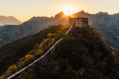 Castle on mountain against sky during sunset