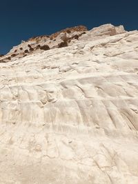 Low angle view of desert against clear sky