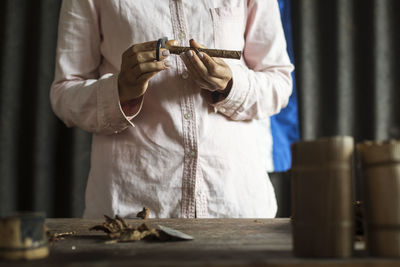 Midsection of man working on table