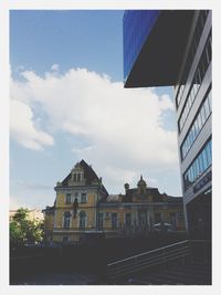 Low angle view of buildings against cloudy sky