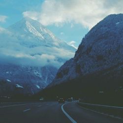 Scenic view of mountains against cloudy sky