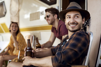 Side view of man looking away sitting on chair