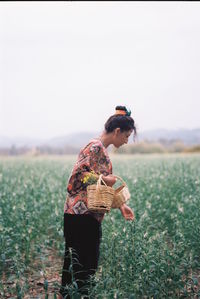 Side view of man standing on field