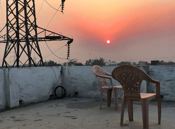 View of an empty chairs at sunset