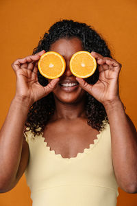 Midsection of woman holding heart shape