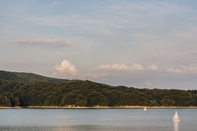 Scenic view of lake and mountains against sky