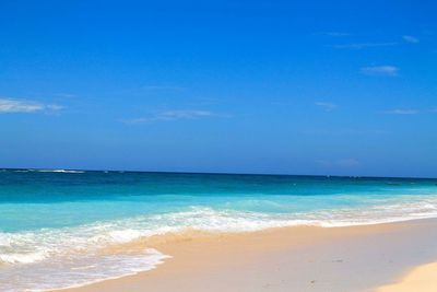 Scenic view of sea against blue sky