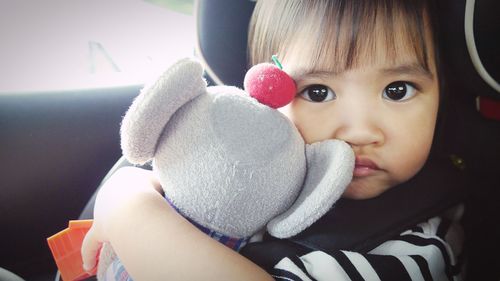 Portrait of cute boy with toy