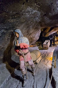 Rear view of man working on rock