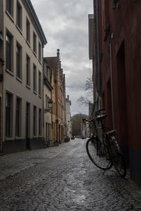 Street amidst buildings against sky in city