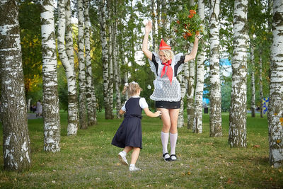 Rear view of woman standing in forest