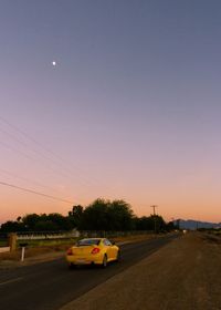 Car on road at sunset