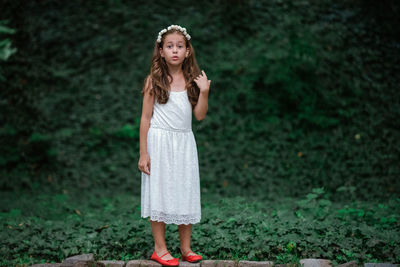 Portrait of boy standing on land