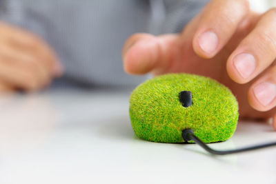 Close-up of man playing with ball on table