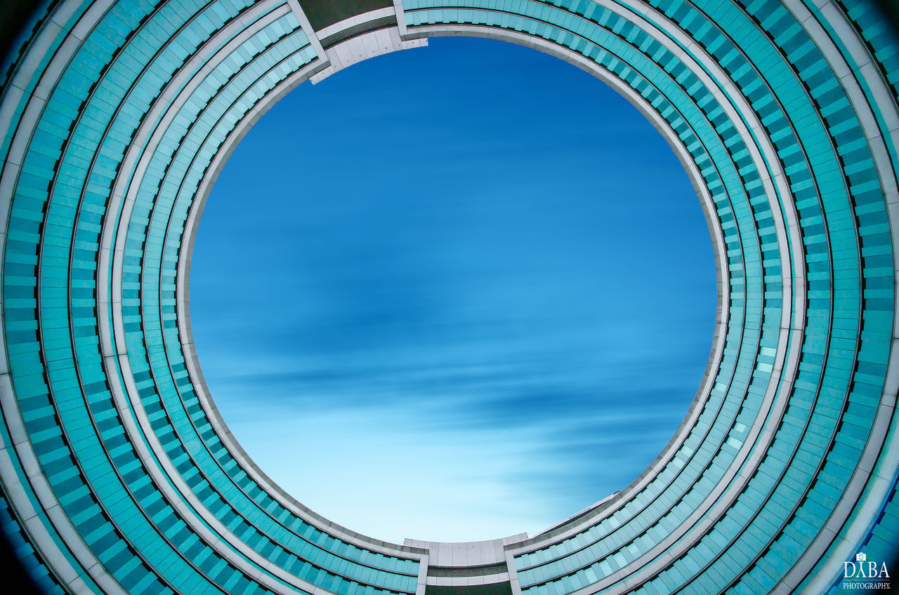 DIRECTLY BELOW SHOT OF MODERN BUILDING AGAINST SKY