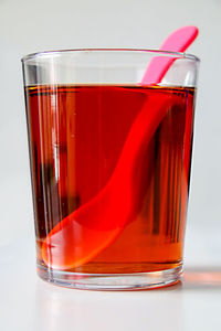 Close-up of red drink served on table