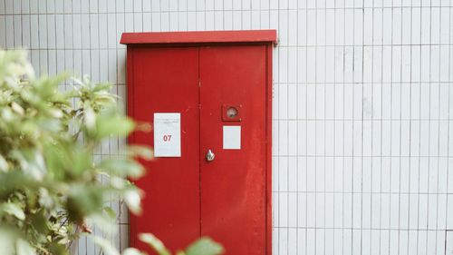 Close-up of red mailbox on wall