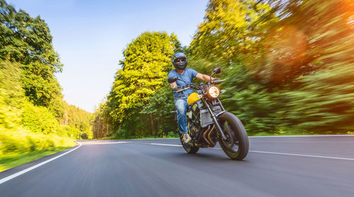 Man riding motorcycle on road
