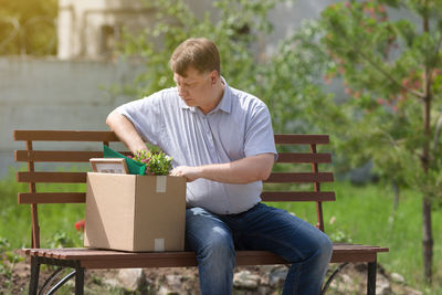 Man sitting on bench in park