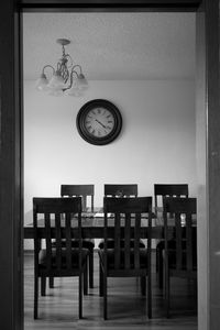 Empty chairs and table against wall at home