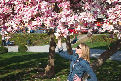 Woman wearing sunglasses standing in park